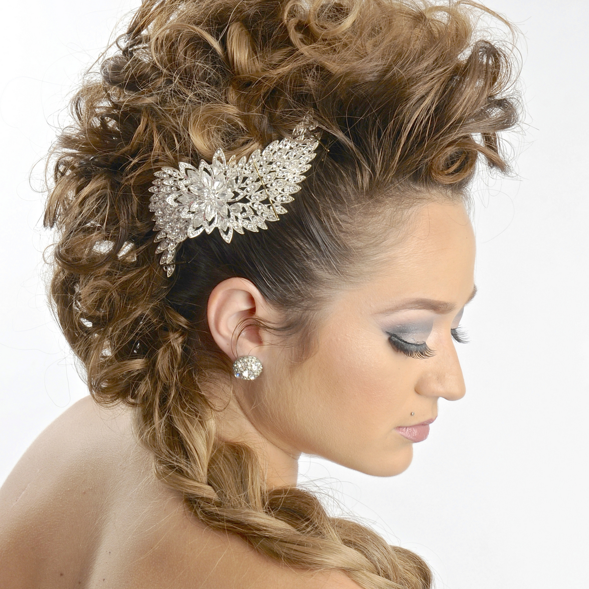 Intricate special-occasion updo with a jeweled hairpiece
